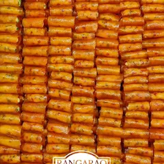 Neatly arranged rows of our special Mango Rolls. This seasonal sweet is a delightful fusion of fresh mango pulp and other ingredients, creating a unique dessert for your events.