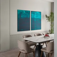 The "Hover" dining table, made of marble, steel, and concrete, is paired here with a striking teal diptych I painted. The sleek wall detailing and fluted texture add a refined visual break, creating a sophisticated and cohesive dining setting.
