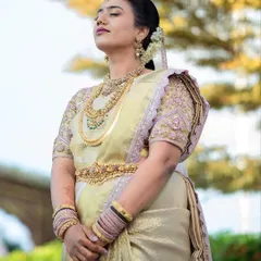 The bride takes a quiet moment to herself, her eyes closed in serene contemplation. This portrait captures the inner peace and beauty of a bride on her wedding day.