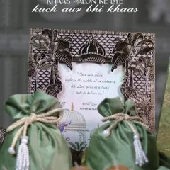 Khaas palon ke liye, kuch aur bhi khaas. This wedding invitation hamper, featuring a beautifully detailed brass frame and elegant potlis, is crafted to make your special moments even more memorable.