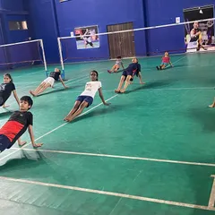 Players holding a core-strengthening and flexibility pose during our yoga session. This kind of conditioning is vital for powerful smashes and agile court coverage.