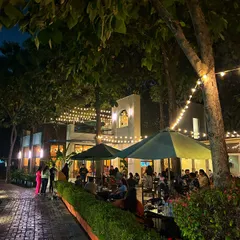 The cafe and patio look magical at night, with string lights creating a warm and inviting atmosphere for dinner and drinks.