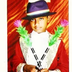 A throwback to my early days as a young performer. Even back then, I was fascinated with the classic magician's look, complete with a hat and colorful props.
