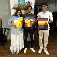A group of friends showing off their unique paintings from our July workshops. We love offering a variety of activities, like puzzle painting and clock painting, to keep things fresh.