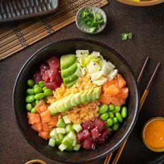 A vibrant salmon and tuna poke bowl for YouMee. This top-down shot highlights the fresh ingredients, colors, and textures, making it perfect for delivery apps and social media.