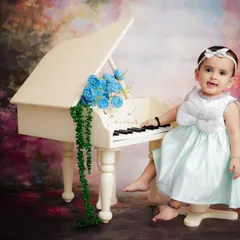 A mini maestro at her piano. This whimsical setup with a tiny grand piano and floral accents is perfect for capturing your baby's playful side.
