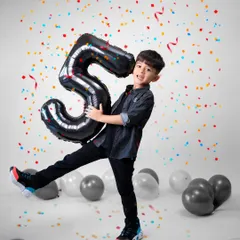 Celebrating a milestone like turning five should be full of energy and joy. I designed this studio setup with bright confetti and balloons to match his vibrant personality. My goal is to capture the pure, unscripted happiness of the moment, creating a memory as lively as the celebration itself.