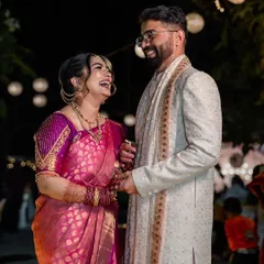 A moment of pure, uninhibited laughter during an evening celebration. We focus on capturing these genuine emotions that truly define the joy of your special day.