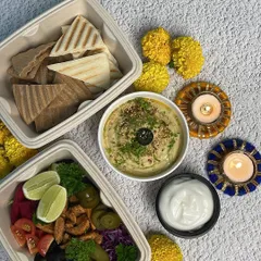 The complete Pita Hummus meal, including a vibrant salad with a lime wedge for that extra zing. It's a healthy and delicious option for your party.