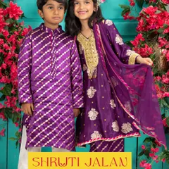 Creating coordinated outfits for brothers and sisters is one of my greatest joys. This vibrant purple set features a silk kurta with diagonal zari work for him and a matching sharara with intricate gold embroidery for her, perfect for a wedding or festive event.