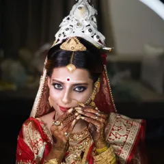 A close-up bridal portrait focusing on the delicate details of the 'mukut' and the bride's expressive eyes.