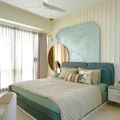 This serene master bedroom is a restful retreat anchored in a calming sage green palette. The design features a custom textured headboard and an MDF back wall, while a tinted mirror panel and fluted glass wardrobe add layers of understated luxury and functionality.