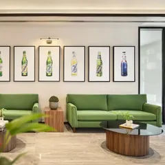 A comfortable waiting lounge at the Carlsberg head office. The design uses brand-aligned colors and curated artwork depicting the company's products to create a space that is both a relaxing area for visitors and a subtle extension of the brand's story.