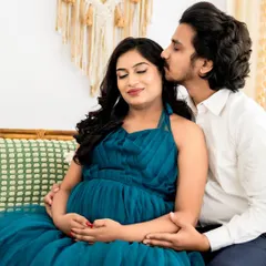 A tender kiss and a gentle embrace. We love capturing these quiet, intimate moments during a couple's maternity photoshoot, preserving the deep connection before the baby arrives.