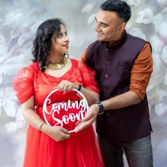 A classic and joyful announcement. This couple's "Coming Soon" sign is a simple and sweet way to share their happy news in a studio portrait.