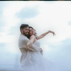 A dreamy, joyful embrace with the sky as the backdrop. The soft focus and genuine smiles create a light and airy pre-wedding photo that feels both romantic and carefree.