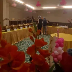 A birthday party setup in an indoor banquet hall. The pink balloon decor shows how we adapt our catering to any private celebration, making it special and memorable.