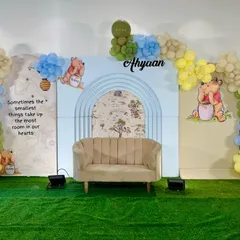 A sweet and simple Winnie the Pooh theme for Ahyaan's cradle ceremony. The backdrop features a gentle blue arch, classic Pooh illustrations, and a soft balloon garland.