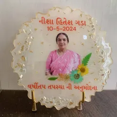 A lovely memorial frame with a photo, name, and significant date. The white resin is accented with gold foil and preserved flowers.
