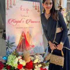 Seeing my designs come to life is the happiest feeling. Here is a beautiful bride posing next to the wedding and reception welcome board I designed for her, featuring a custom caricature and a soft, romantic theme.