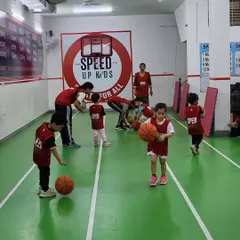 A young athlete focused on his dribbling. We use smaller, lighter balls for our younger groups to make it easier for them to learn and build confidence in sports like basketball.