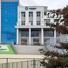 A closer view of the EuroSchool facade and the adjacent tiered seating area, which serves as a small amphitheater for outdoor events.