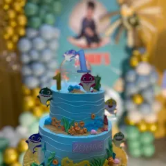 Here's the Baby Shark cake at the party, fitting in perfectly with the themed decorations. I love coordinating with event planners to create a cohesive look.