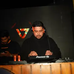 In deep concentration, lining up the next track on my Pioneer DDJ. Every transition is crafted to keep the energy flowing.