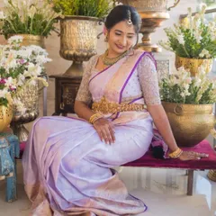 A full-length shot of Bhavana at her housewarming. The elegant lavender saree and custom blouse make for a perfect celebratory outfit.