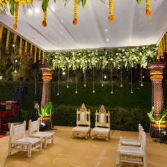 The mandap at night, with hanging bells and lights creating a warm and intimate glow for the evening ceremony.