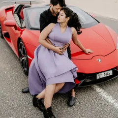 For the adventurous couple, a pre-wedding shoot in Dubai is an unforgettable experience. This shot with a vibrant red Lamborghini against the desert highway captures a story of modern luxury and romance.