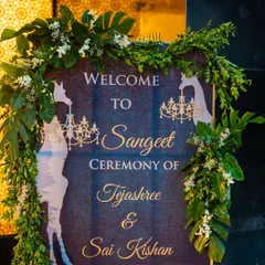 The welcome signage for a tropical-themed Sangeet. The design incorporates giraffe silhouettes and chandeliers, giving guests a hint of the unique and playful decor inside.