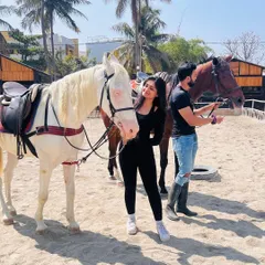A candid moment from a photoshoot, showing a couple getting comfortable with our calm and friendly horses. We help create a relaxed environment for authentic shots.