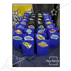 Party favors ready for the little astronauts to take home. These custom goody bags are decorated with fun space-themed stickers, ensuring the party fun continues even after it's over.