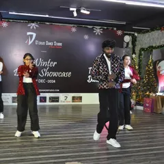 A wide shot of a group performance at our Winter Dance Showcase. Our studio provides a great backdrop for these intimate and festive events.