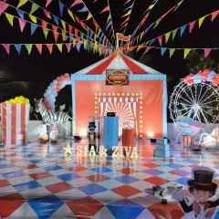 The main stage for a circus-themed party, featuring a custom-printed backdrop, checkered flooring, and various props. I ensure every element, from the lighting to the character cutouts, fits the chosen theme perfectly.