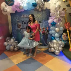 The birthday girl poses with her mom in front of our stunning Frozen-themed backdrop. We ensure our decorations create the perfect photo opportunities for you to capture these precious memories.