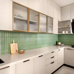 The kitchen is rooted in calm with a soft sage green backsplash that feels like a whisper from nature. I paired this with the subtle texture of fluted glass on the upper cabinets for a touch of shimmer and light.