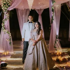 A cocktail night is a story told with romantic lights and happy people. For Ridhi and Prashanth, we designed this dreamy stage with lavender drapes and candlelit steps, a vision brought to life with the bride's own creative ideas.