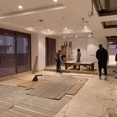 The on-site execution phase begins. This image shows a 4500 sq ft apartment at the start of the interior work, with materials laid out and the team beginning the transformation from a bare shell.