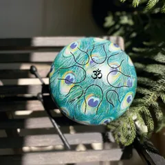 This beautifully decorated Happy Drum, with its peacock feather design and Om symbol, is as visually stunning as it is sonically pleasing. It is lightweight, portable, and accessible for players of all skill levels.