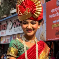It's not just about the crowds, but the individuals. A close-up portrait of a young girl during the Gudi Padwa Shobhayatra, her smile and traditional Marathi attire telling a story of cultural pride.