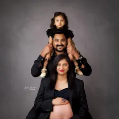 A powerful and unique family maternity portrait. The stacked pose creates a strong, visually interesting image that celebrates the family unit before the new arrival.