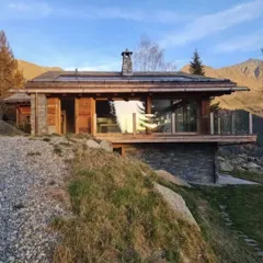 Our Swiss chalet project basking in the sun, showcasing site-specific design that respects its alpine environment. We used local stone and wood to create a home that feels both modern and deeply rooted in the landscape.