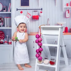 Capturing the pure joy of a toddler in our "Little Chef" themed photoshoot. Dressed in a chef's hat and apron, this little one's smile is the main ingredient for a perfect picture.