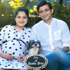 Your fur baby is family too. This happy couple included their adorable dog in their announcement photo, making their family portrait complete and adding a touch of playful joy to their maternity session.