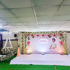 A lovely floral setup for a naming ceremony. We created a personalized backdrop with the baby's photo and a stunning crescent moon cradle adorned with fresh flowers.