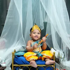 A happy little Krishna, smiling with his flute. This shot captures the joyful and mischievous spirit of Kanha, perfect for a sitter session.