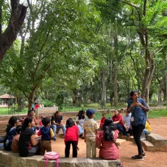 Under a canopy of leaves, with birdsong as our music, I gather our tribe for story time. This is where imaginations run wild, as we share tales of forest creatures and magical adventures, building a community of young explorers and parents.