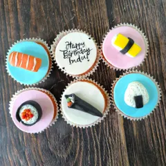 For the sushi lover, this set features a variety of hand-sculpted fondant sushi pieces, including nigiri, maki, and temaki rolls, all sitting on colorful, edible discs.